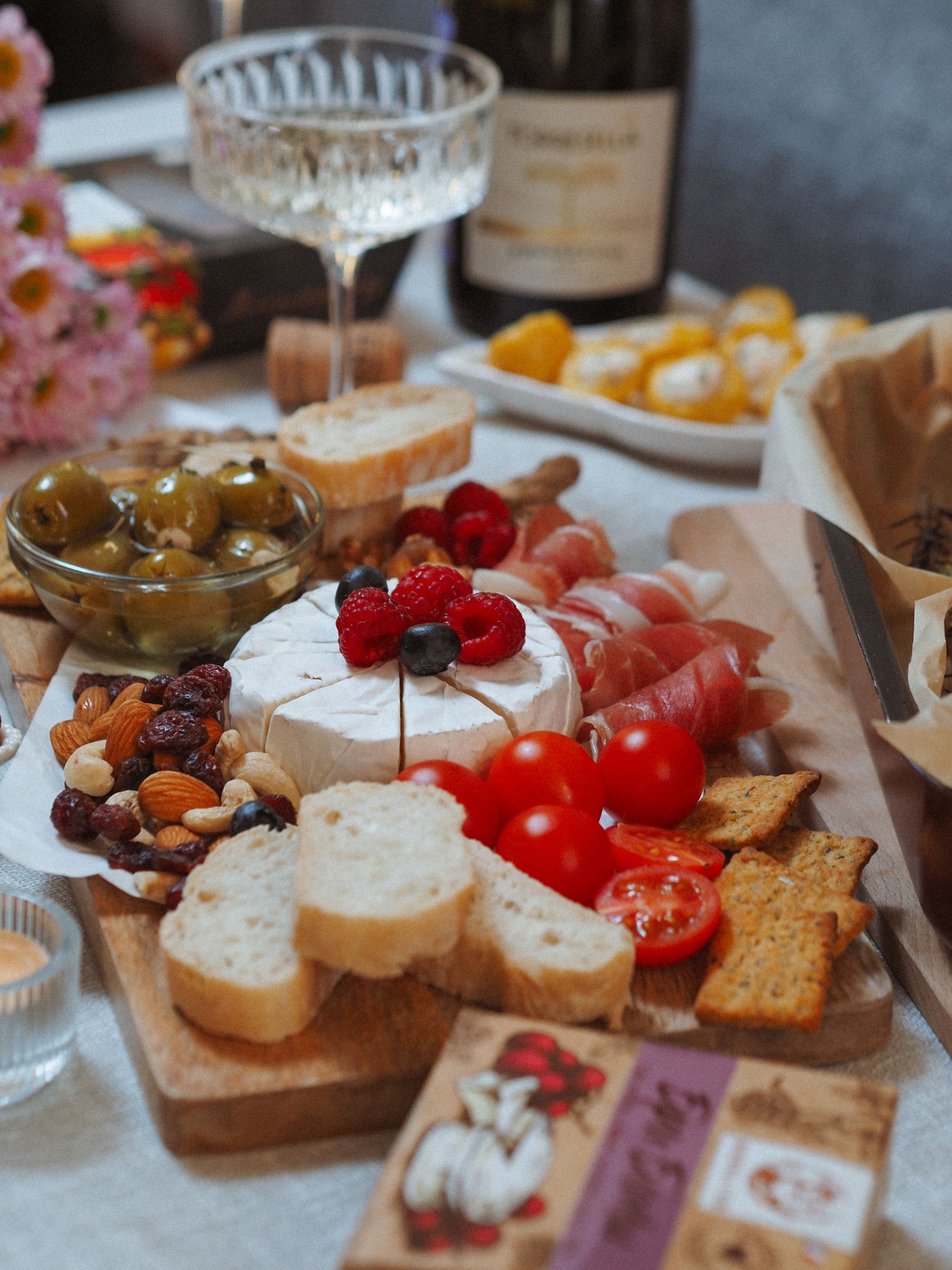 A generous charcuterie board and sparkling wine arranged for a celebration