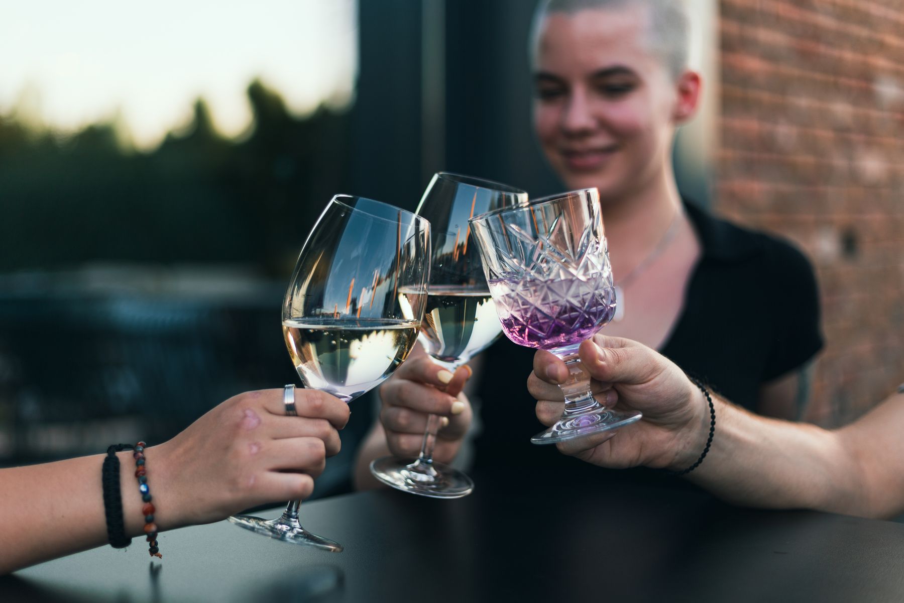 Friends raising glasses together at a relaxed gathering